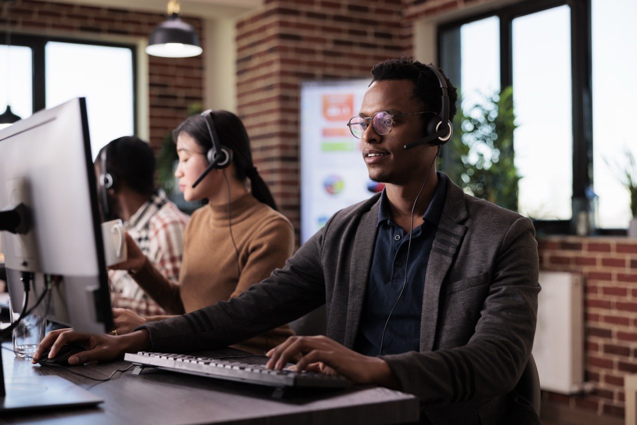 Team of agents on headsets working at their desks